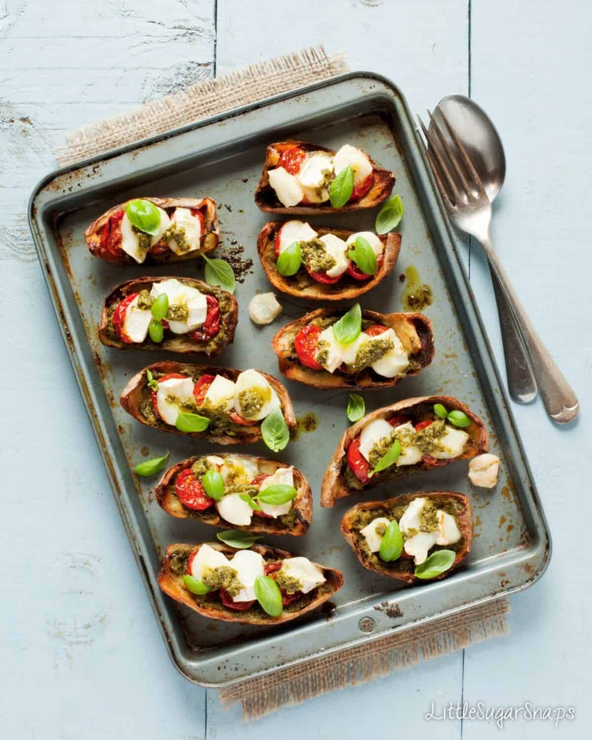 Overhead view of Potato Skins with Pesto and Goats Cheese and tomatoes
