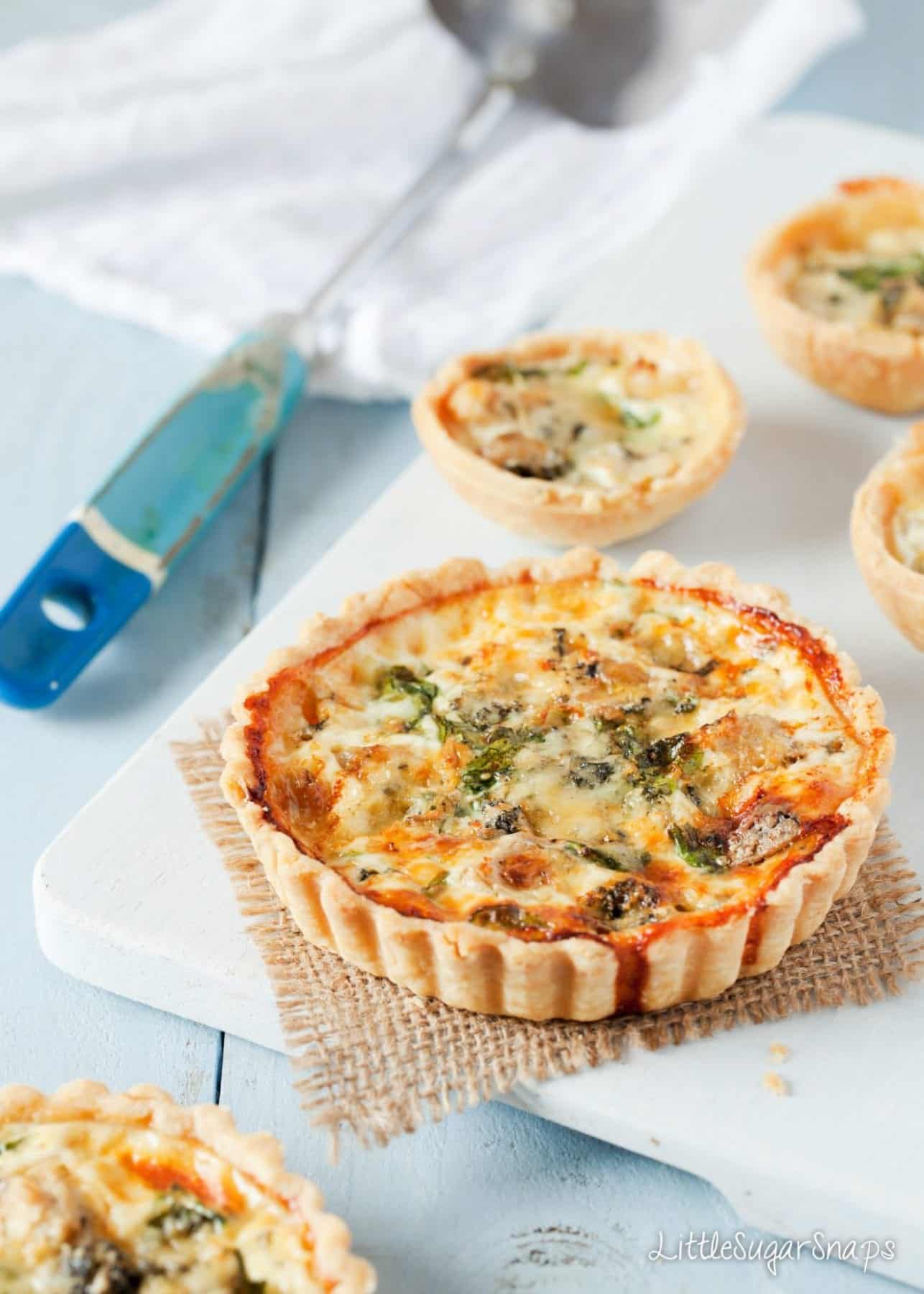Savoury blue cheese tarts on a wooden board