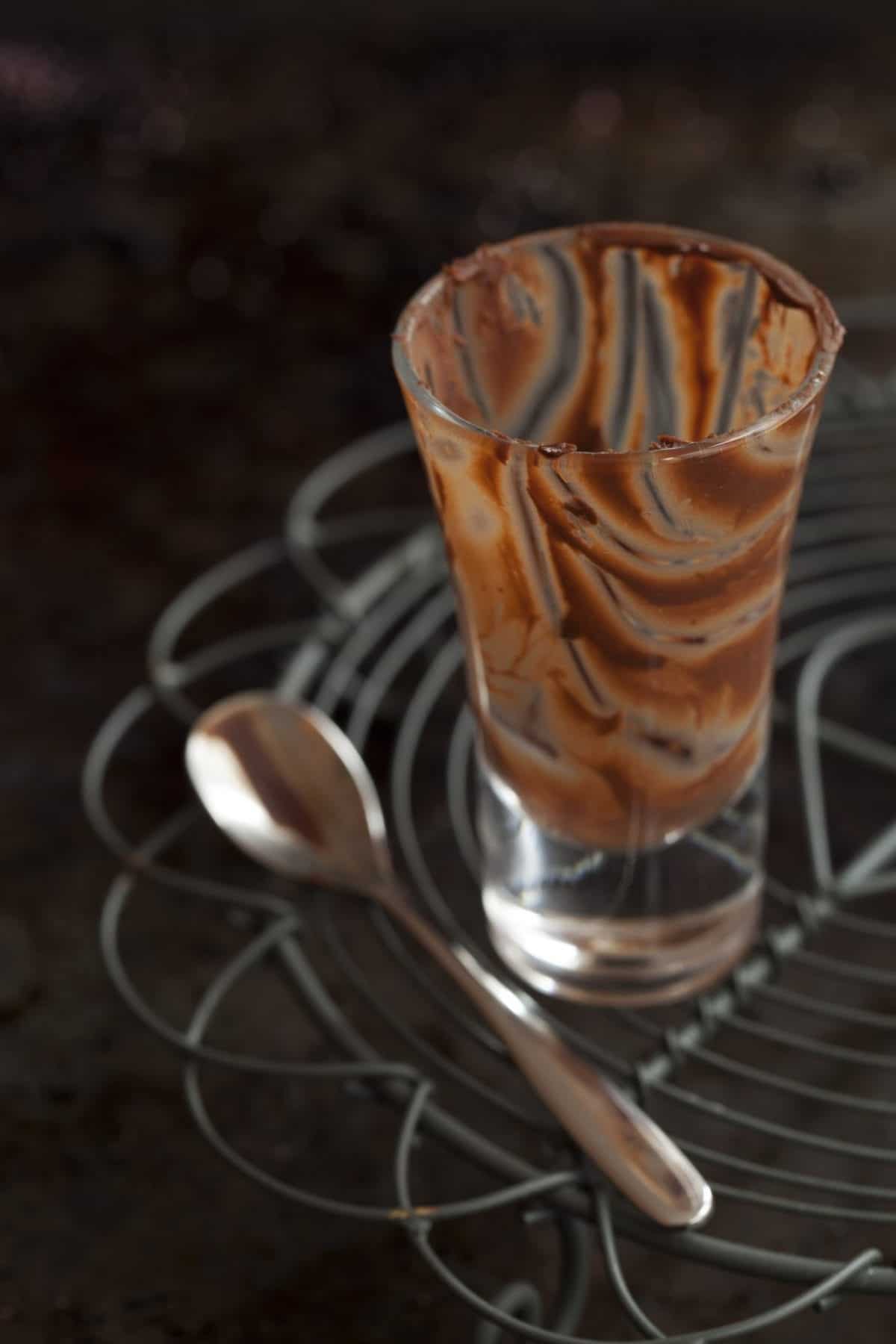 Empty glass containing the remains of a chocolate dessert