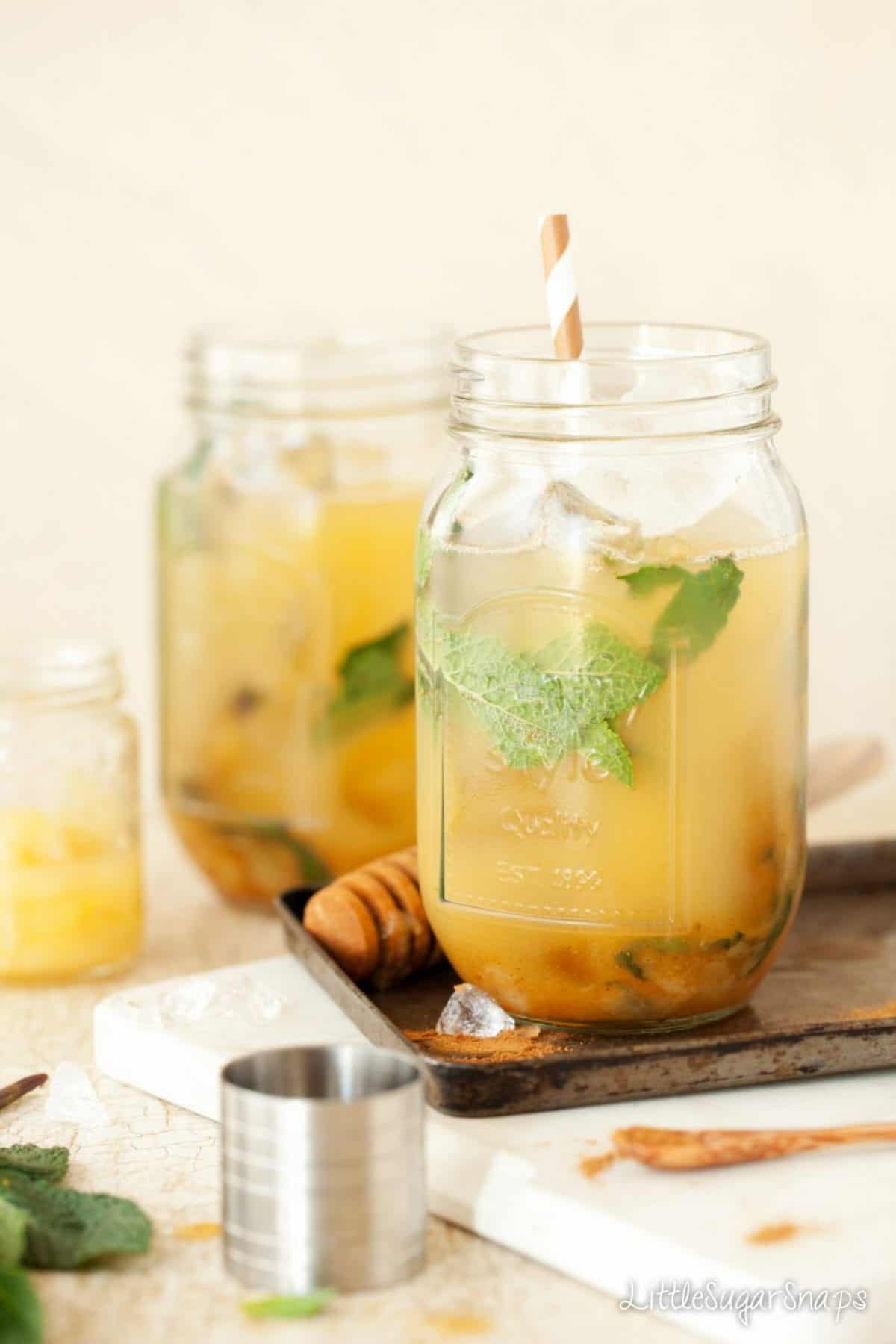 Bourbon Pineapple & Pear Bourbon, pineapple & pear cocktails with mint. Served in jam jars.