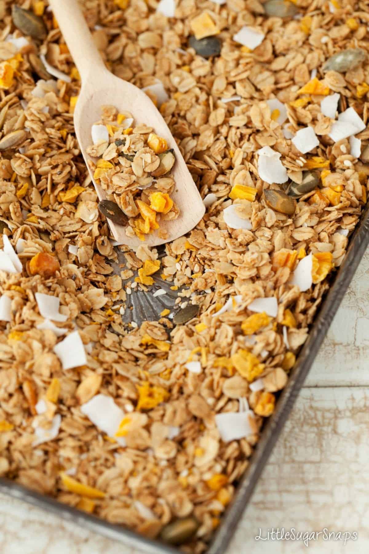 freshly baked granola on a baking tin
