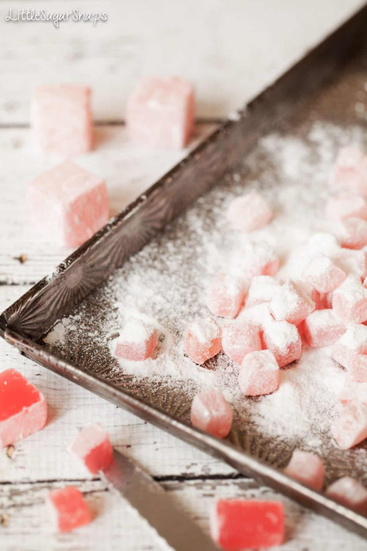 Small pieces of turkish delight on a baking tin