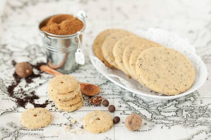 A plate of full-size tea flavoured biscuits plus some mini biscuits next to them. 