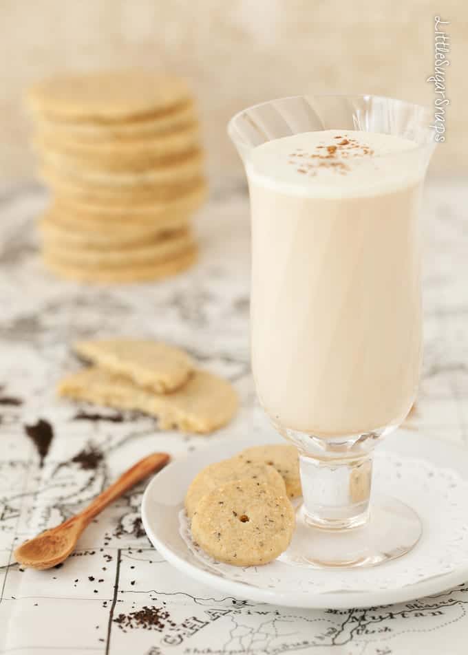 Masala tea latte with a few biscuits at the side