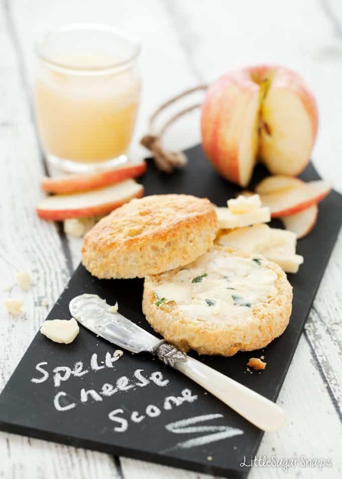 Cheese scone cut open and spread with herby butter