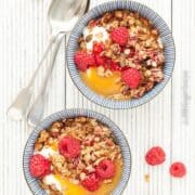 Raspberry Granola Breakfast Bowls with yoghurt, granola, peach puree & fresh raspberries