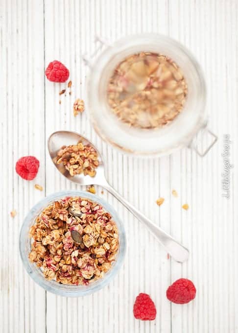 Raspberry Granola in a bowl with a covered jar alongside