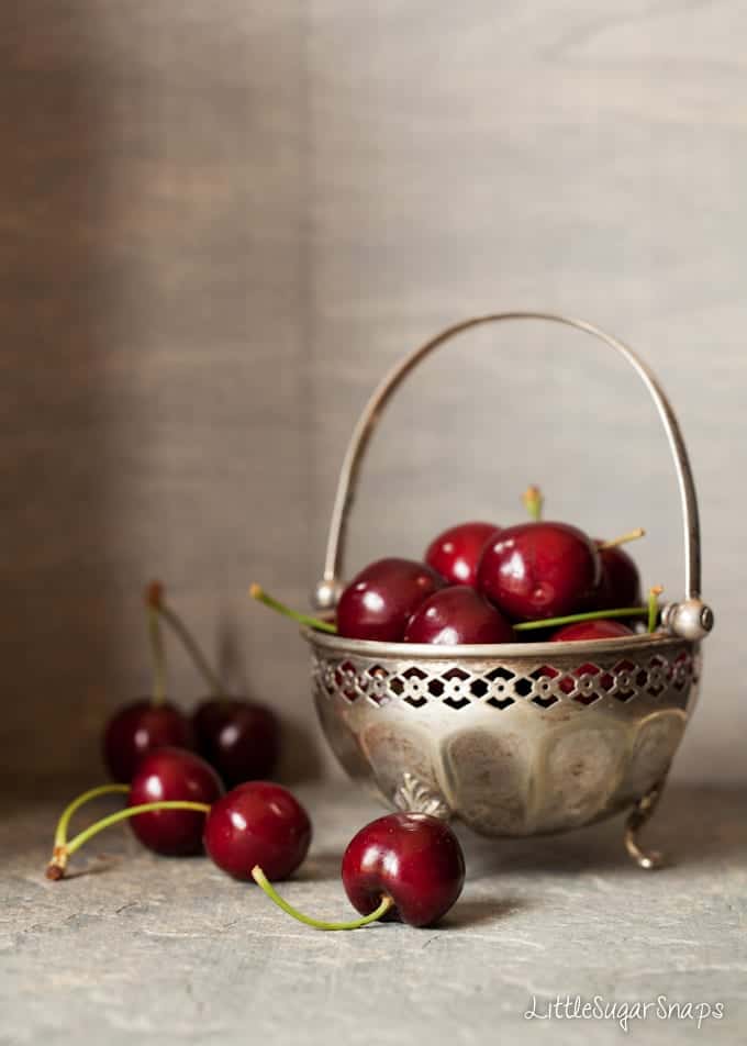 Vintage bowl filled with cherries on a tabletop