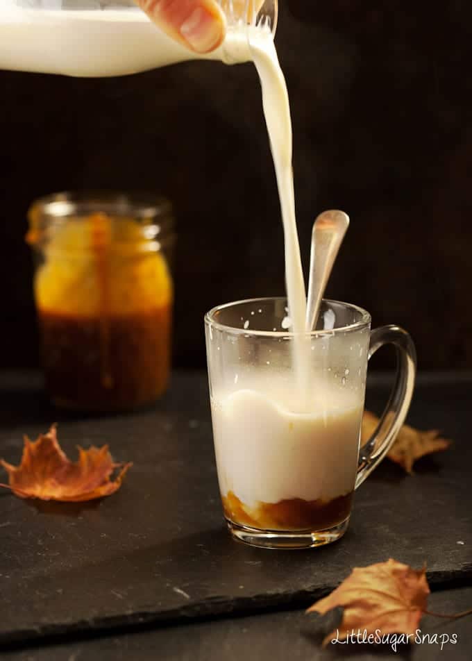 Bourbon Caramel milk drink being poured into a glass mug