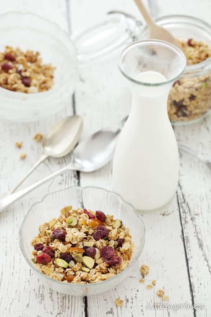 A bowl of homemade Cranberry Granola with a bottle of milk
