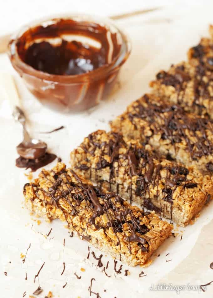 Bars of Brown sugar flapjack being drizzled with chocolate