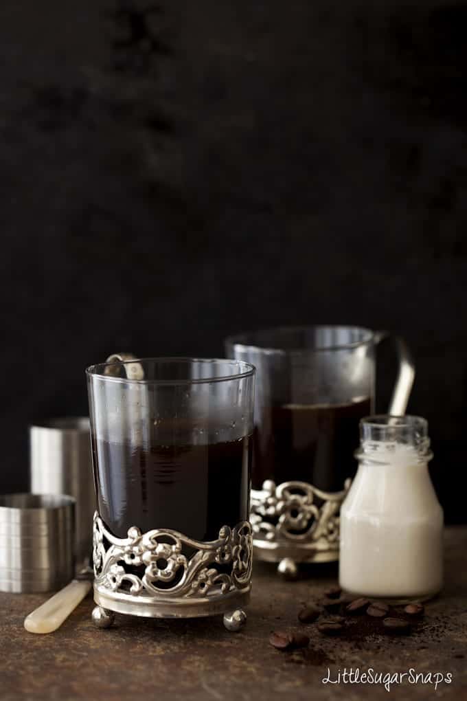 Liqueur coffees in vintage glasses awaiting the cream float