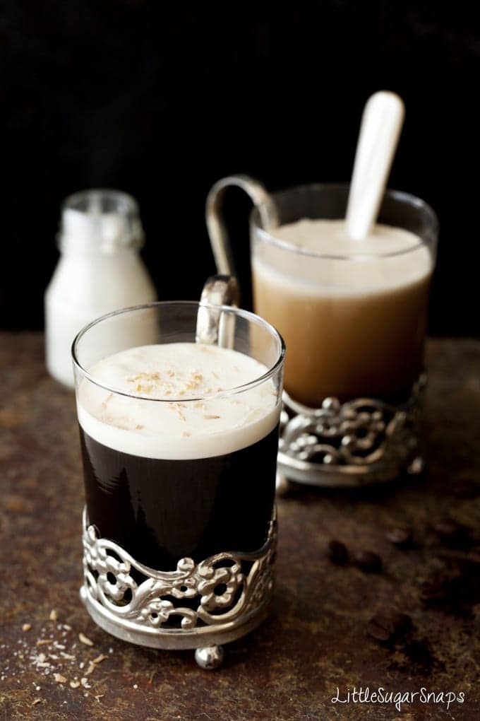 Glasses of liqueur coffee with cream float and dessicated coconut