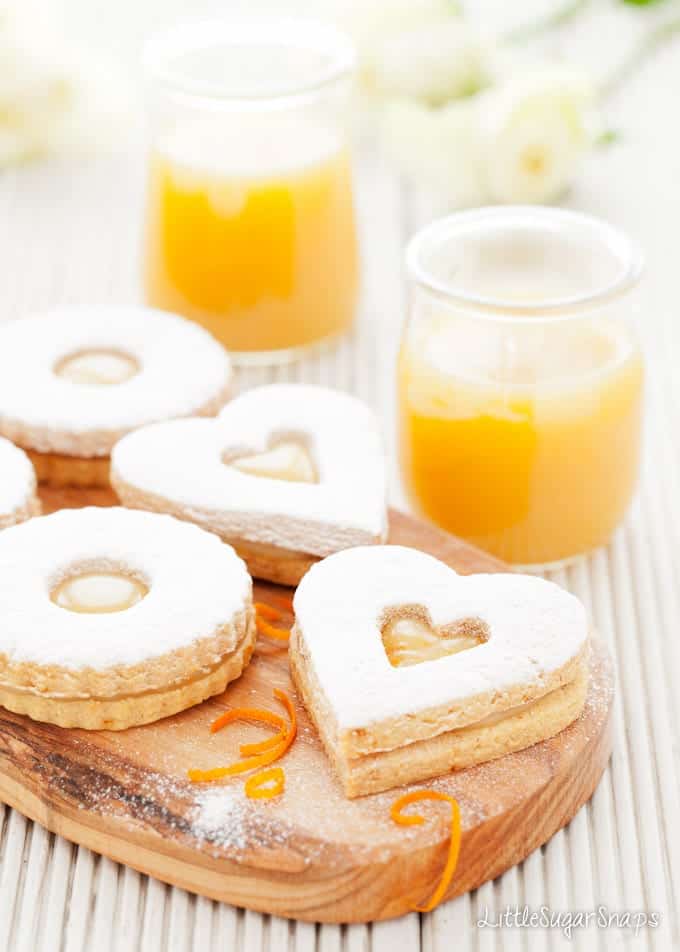 Heart & circle shaped Linzer Cookies filled with orange caramel