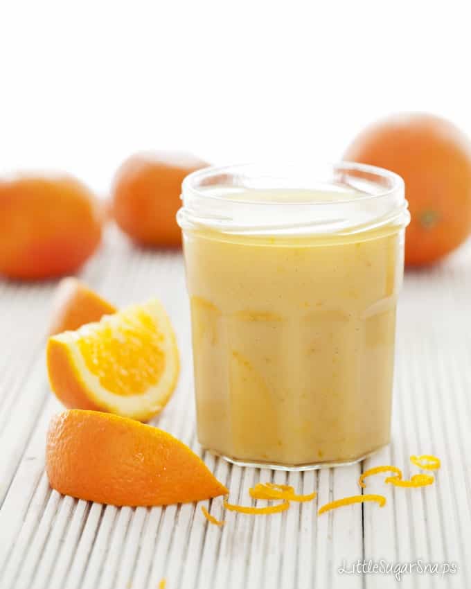 Orange Caramel Spread in a jar with orange wedges