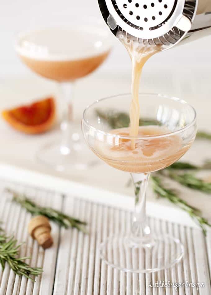 Pouring a Blood Orange cocktail into a glass