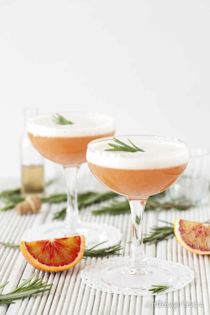 Two glasses of Blood Orange Martini with egg white foam