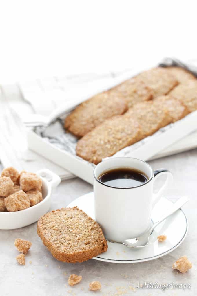 A cup of coffee served with Ginger Spiced Rye Biscuits