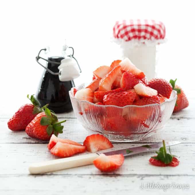 Fresh strawberries in a vintage glass bowl