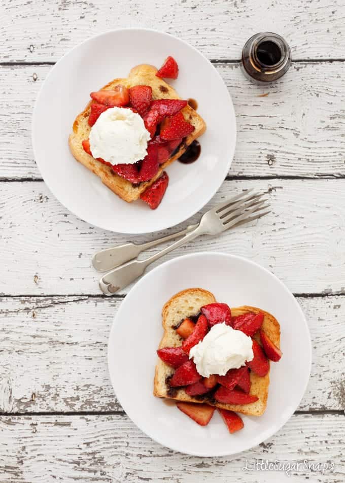 Plates of brioche toast with strawberries, balsamic syrup and mascarpone