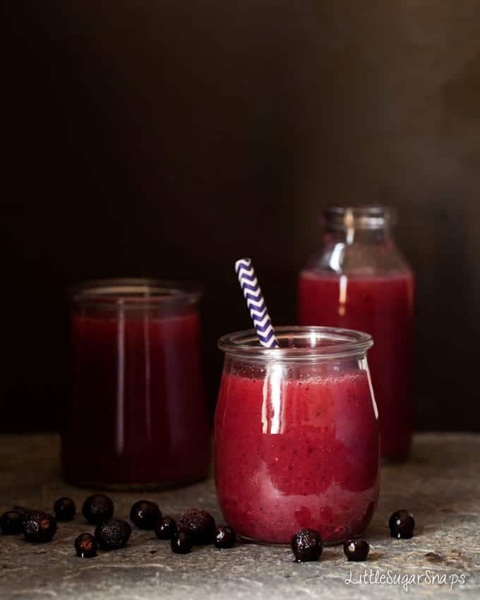 Small glasses and bottles holding Apple Fig Blackcurrant Pear & Carrot Juice