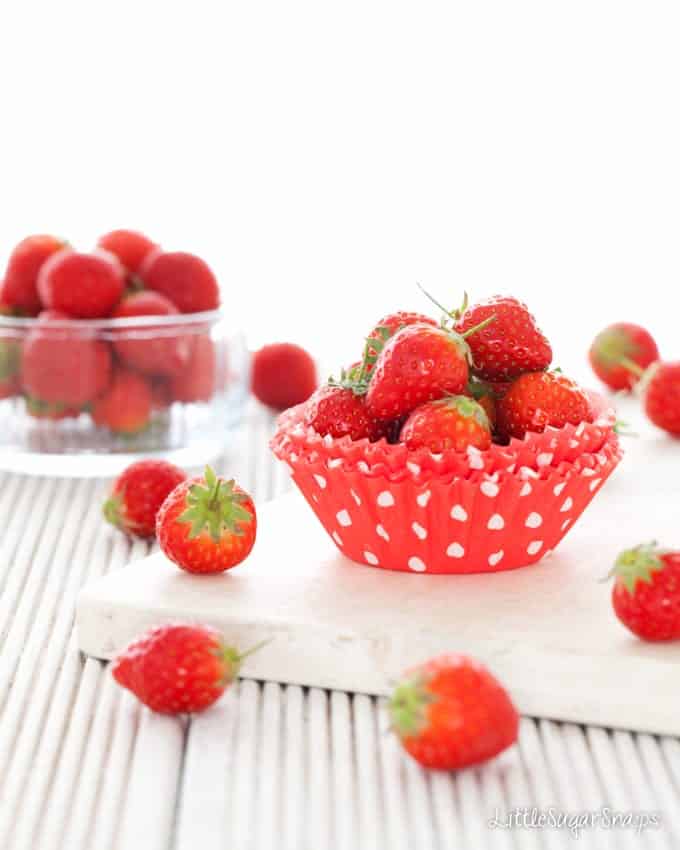 Strawberries in red cupcake cases with white polka dots