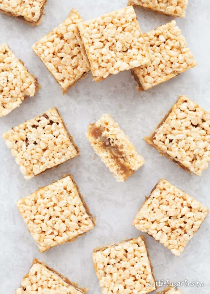 Salted Caramel Rice Krispie Treats with pecans cut into squares on a worktop