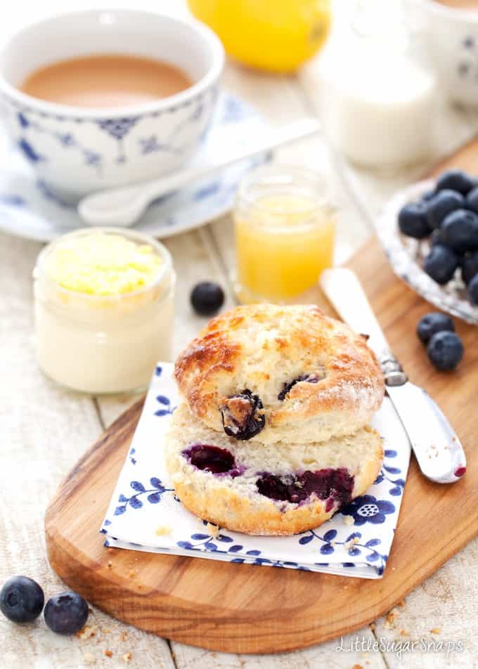 Blueberry scone cut open on a wooden board