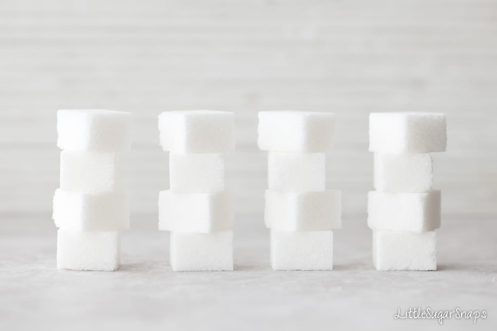 four stacks of white sugar cubes