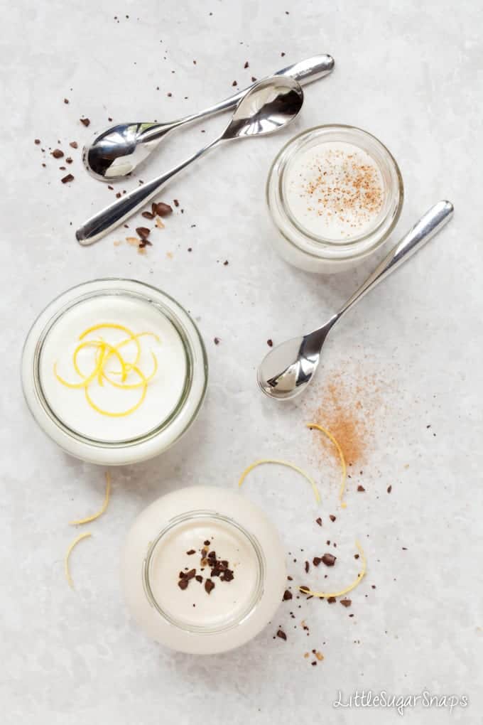 Three small glass pots of various yoghurt flavours