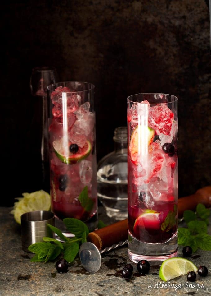 Blackcurrant syrup dripping down ice cubes in a glass