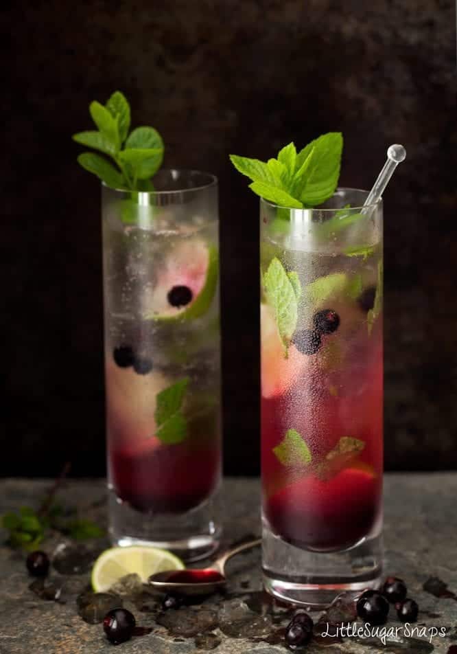 Blackcurrant Mojitos in tall slim glasses