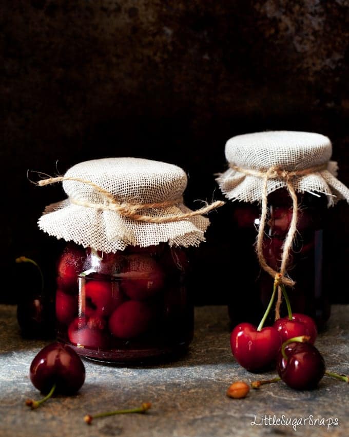 spiced bourbon cherries in jars sealed with string and hessian