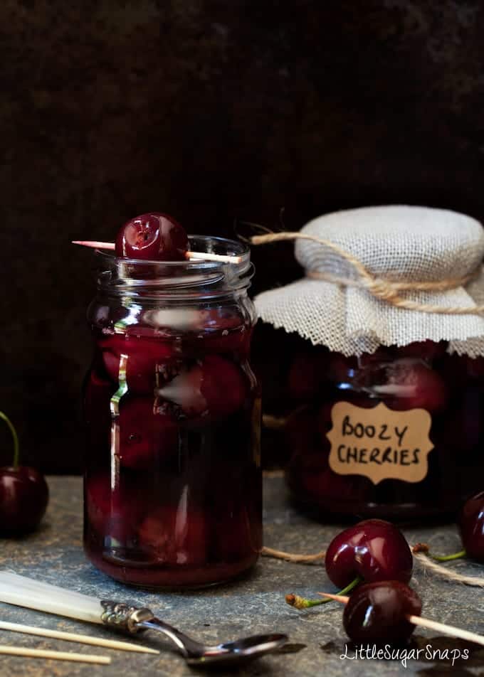 Cinnamon Bourbon Cherries-8588 An open jar of Cinnamon Bourbon Cherries with a cherry resting on the top