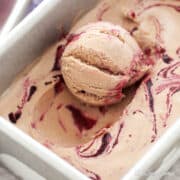A scoop of nutella ice cream with blackberry ripple