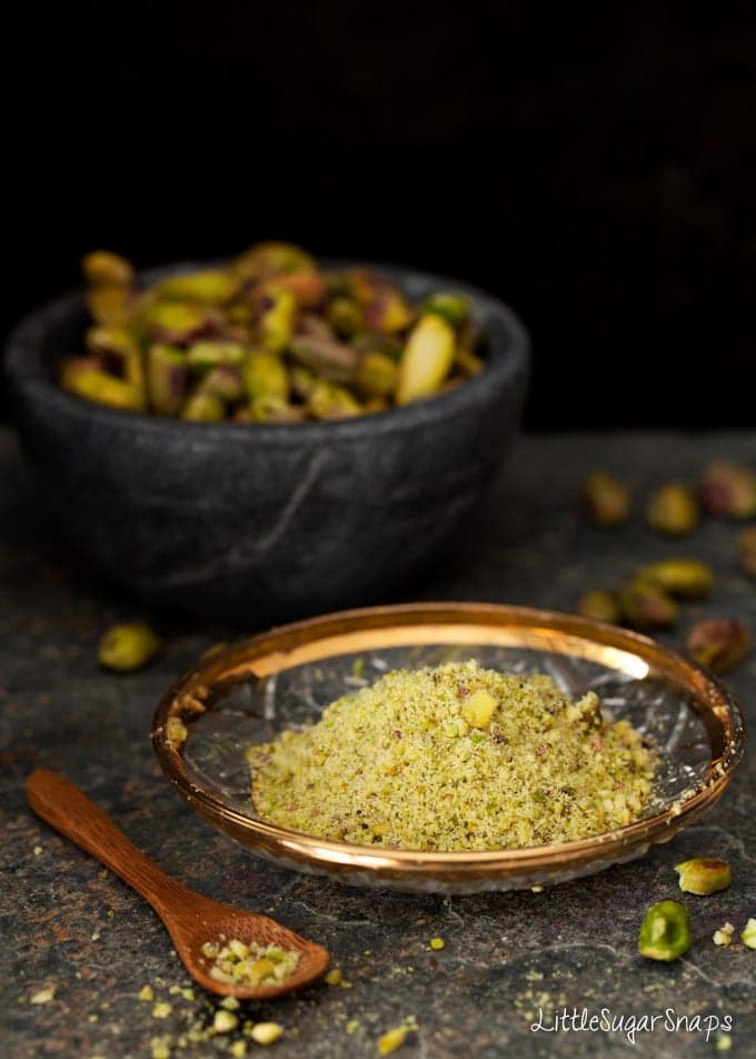 Ground pistachio nits on a small plate.