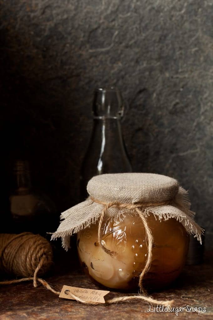 Sealed gift jar of fruit in a liqueur syrup with string and a label.