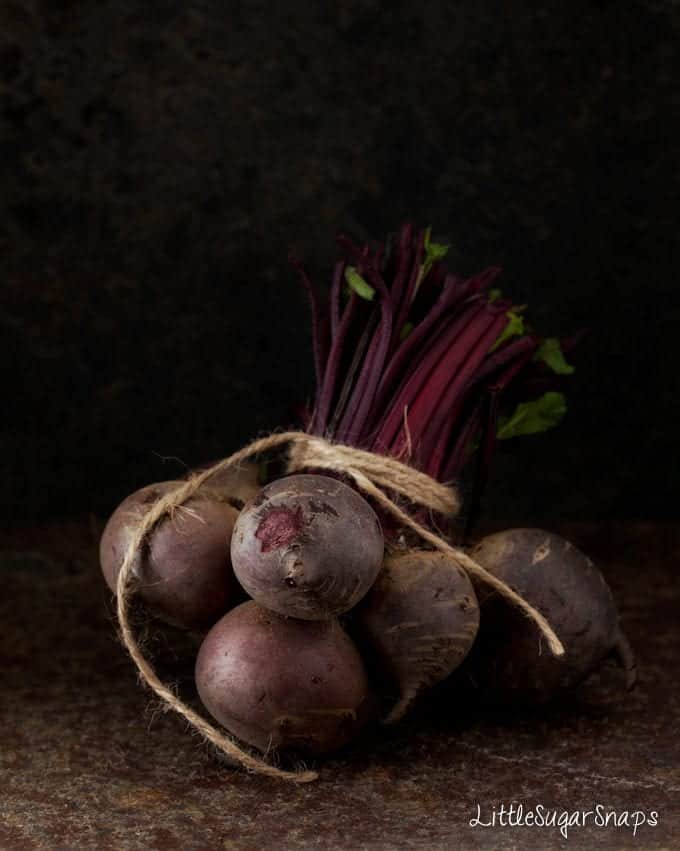 A bundle of raw beetroot tied with string.