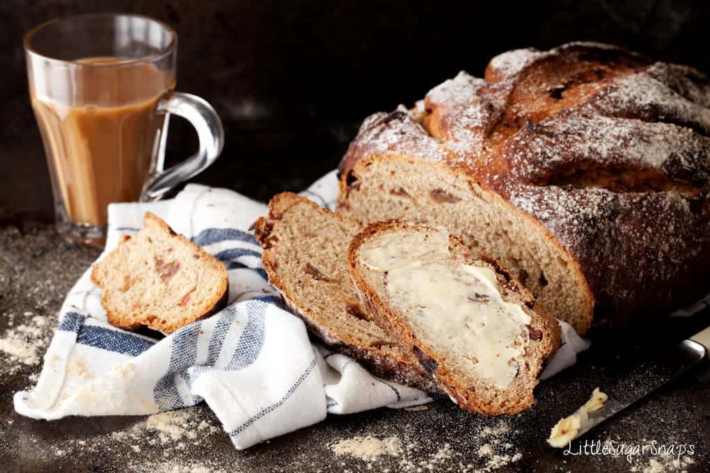 Buttered slices of Coffee Date Rye Bread on a teatowel.