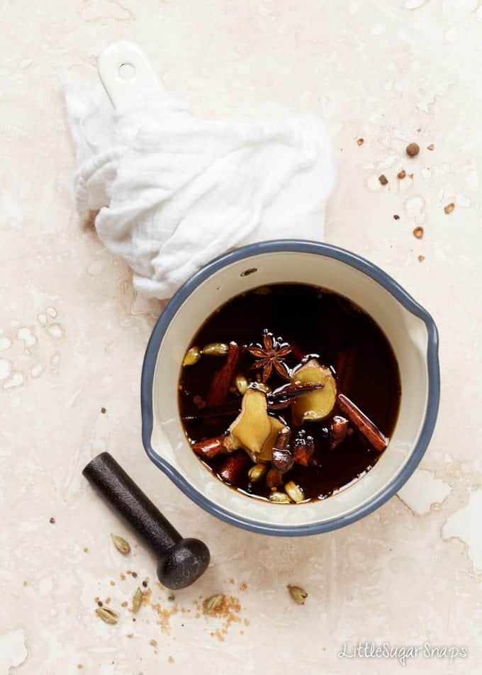 Masala Chai Syrup in a pan with various spices.