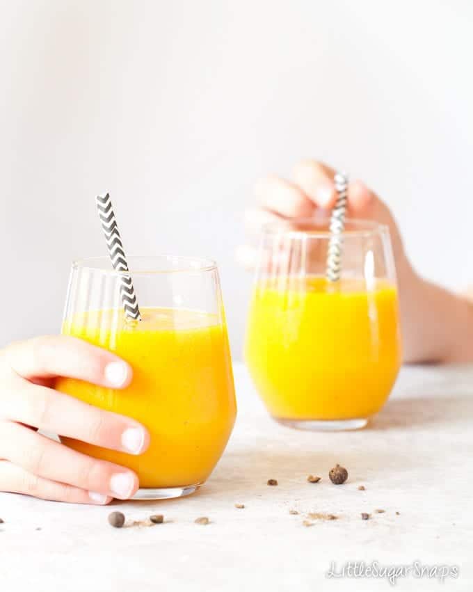 Tropical Turmeric Smoothie Children taking a glass of Tropical Turmeric Smoothie