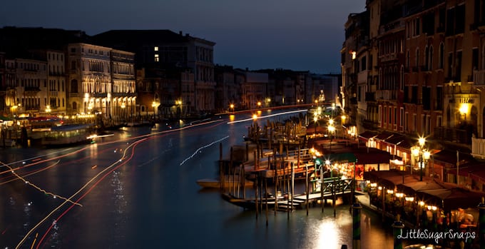 Nighttime view of Venice canal from the Rialto Bridge.