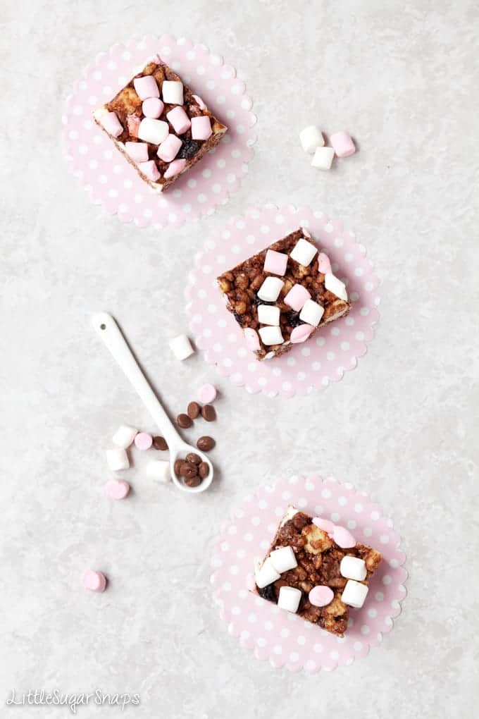 Squares of Rocky Road Chocolate Krispie Treats on pink paper circles