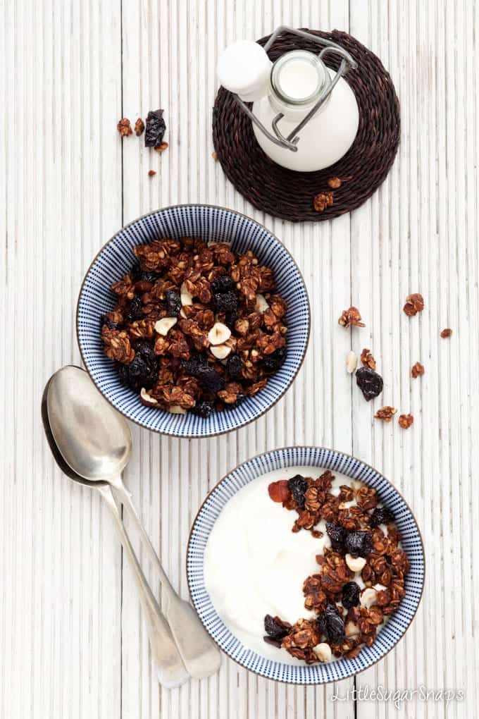 Chocolate granola in bowls with milk and yghurt