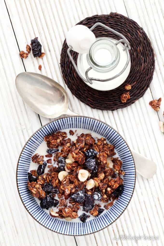 A bowl of chocolate granola with dried cherries and hazelnuts