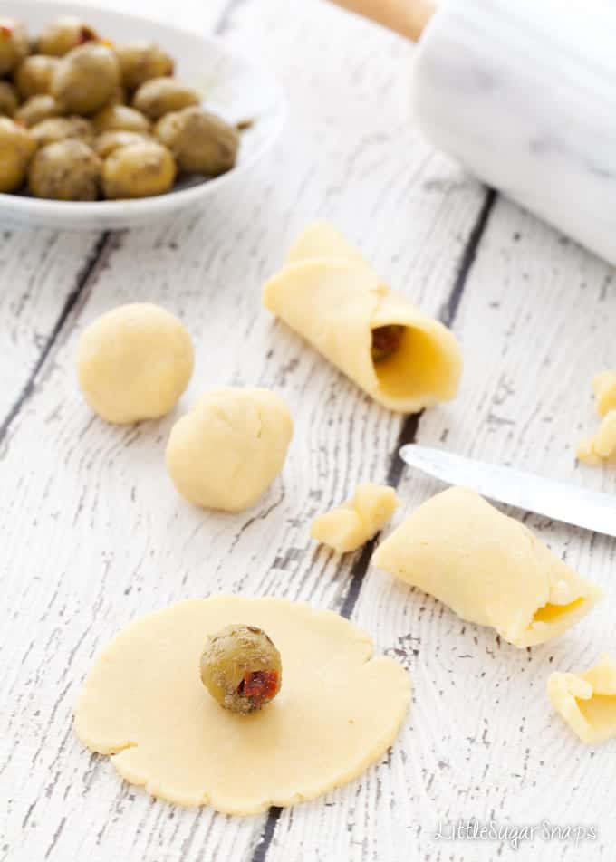 Wrapping olives in parmesan pastry