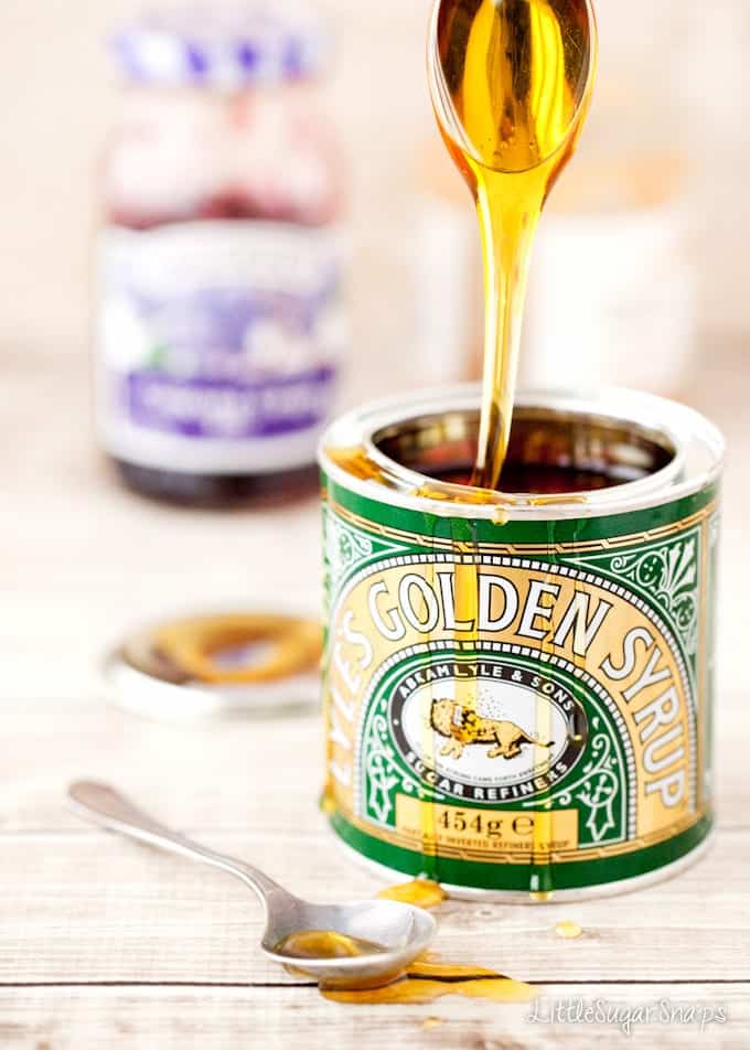 Golden syrup falling from a spoon back into a tin