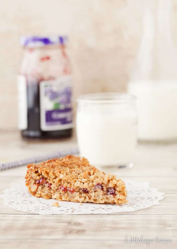 Peanut Butter Flapjack with jam in the middle and a jam-jar behind