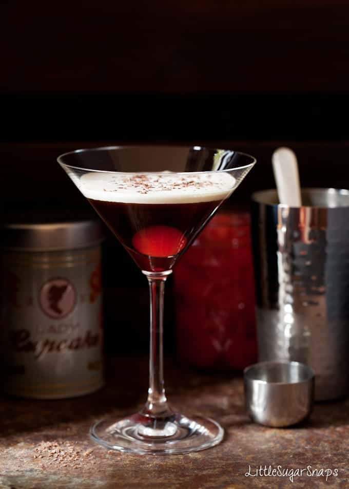 Bourbon Black Forest Cocktail with a float of cream and a maraschino cherry