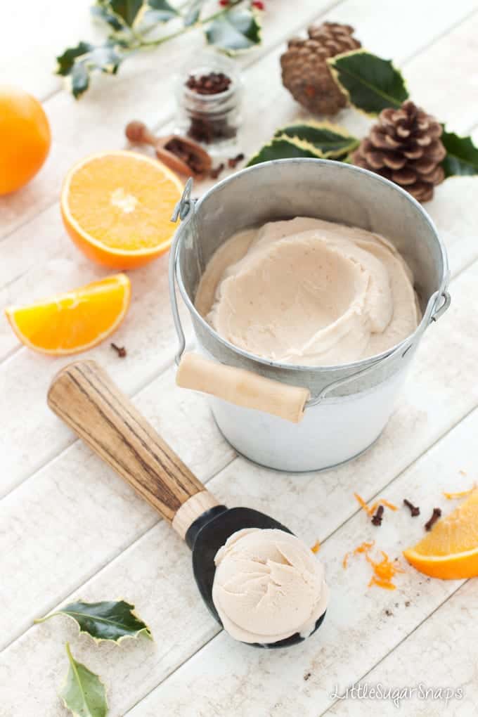 Boozy Orange Clove Ice Cream in a tin bucket